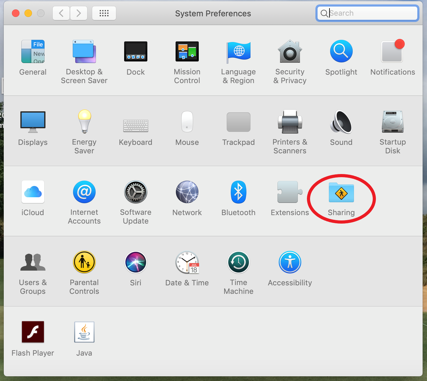The System Preferences panel is open, and the third row has sharing highlighted
